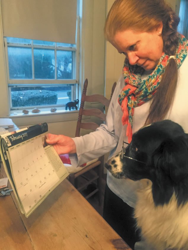 Border collie Franklin checks the calendar with his “mom” 